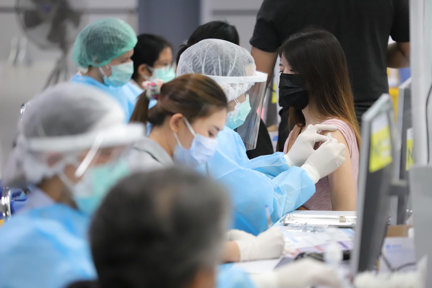 People get vaccinated at Bang Sue Grand Station. The service aims to attract more people to get their jabs ahead of the Songkran festival next month.  Pornprom Satrabhaya