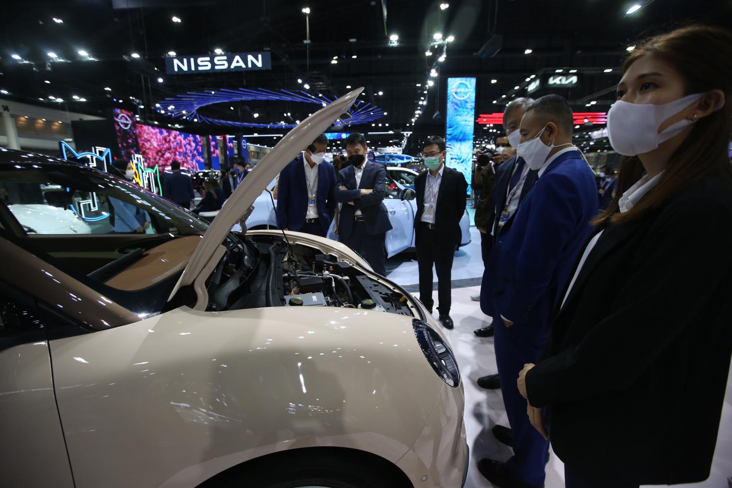 Visitors examine an electric vehicle on display at Motor Expo 2021. (Photo: Varuth Hirunyatheb)