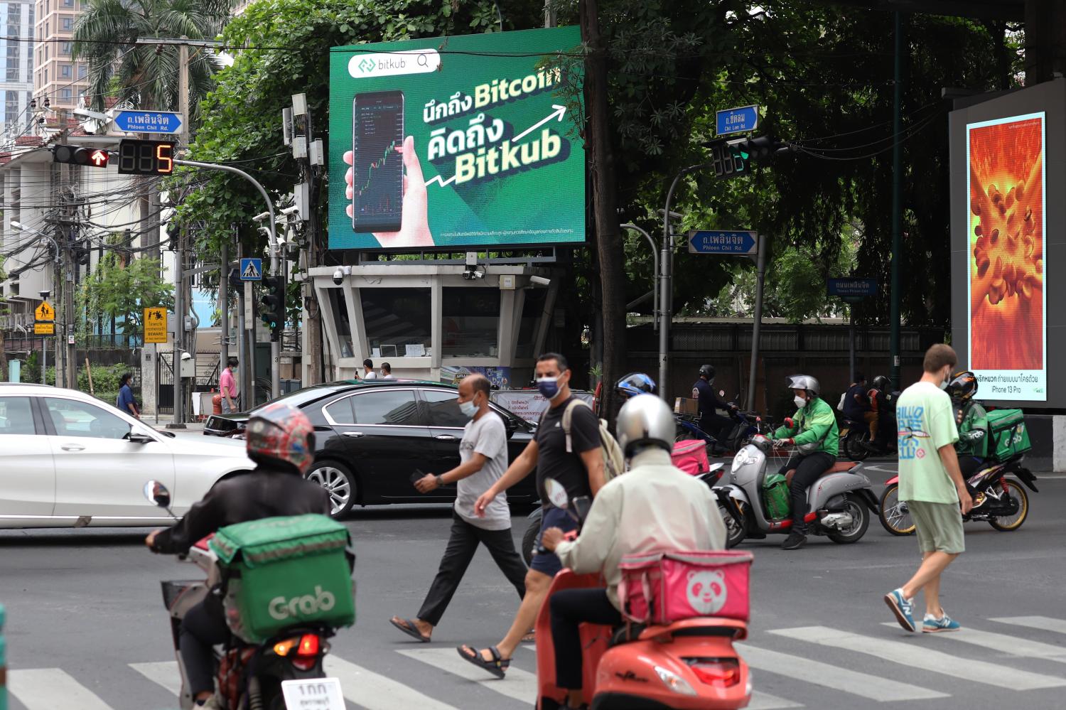 Food delivery drivers make their way through Bangkok's central business district. Nutthawat Wichieanbut