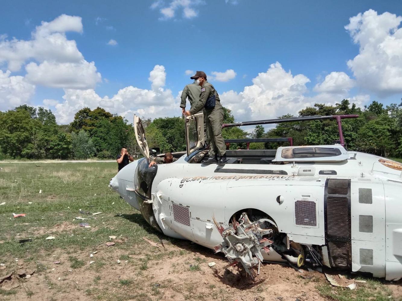 Officers examine the damaged helicopter after the crash. Police photo