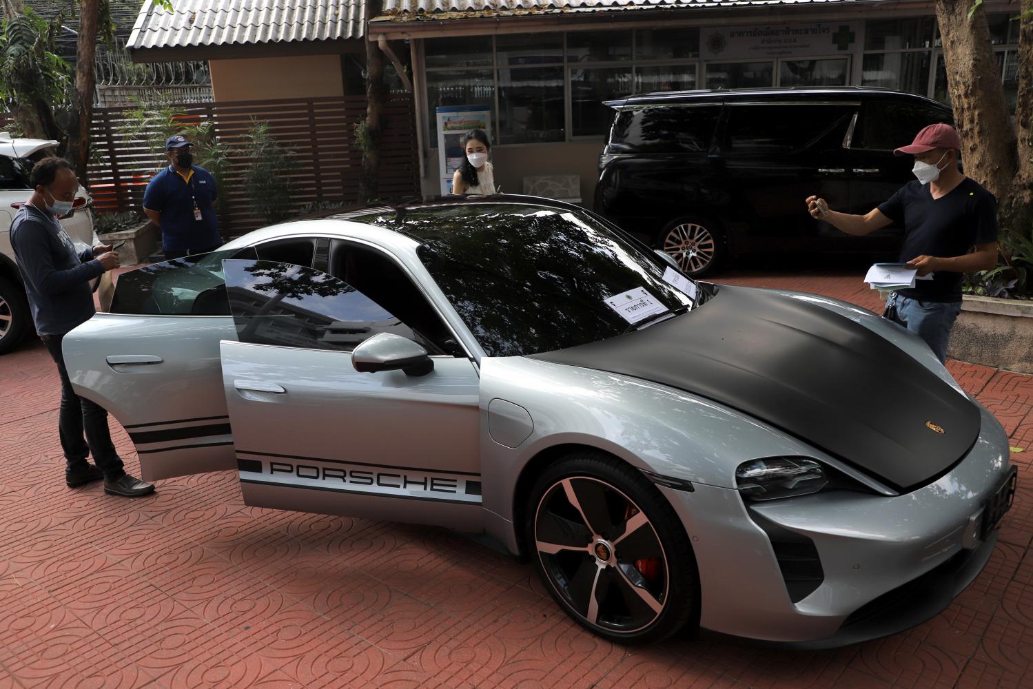 A Porsche Taycan is among luxury items seized from drug traffickers auctioned off by the Office of the Narcotics Control Board on Monday. The car went for 6,580,000 baht. In total 192 luxury goods went under the hammer. (Photo: Chanat Katanyu)