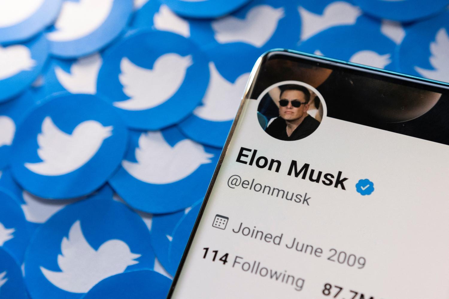 Elon Musk's Twitter profile is seen on a smartphone placed on printed Twitter logos in this illustration taken April 28, 2022. (Reuters photo)