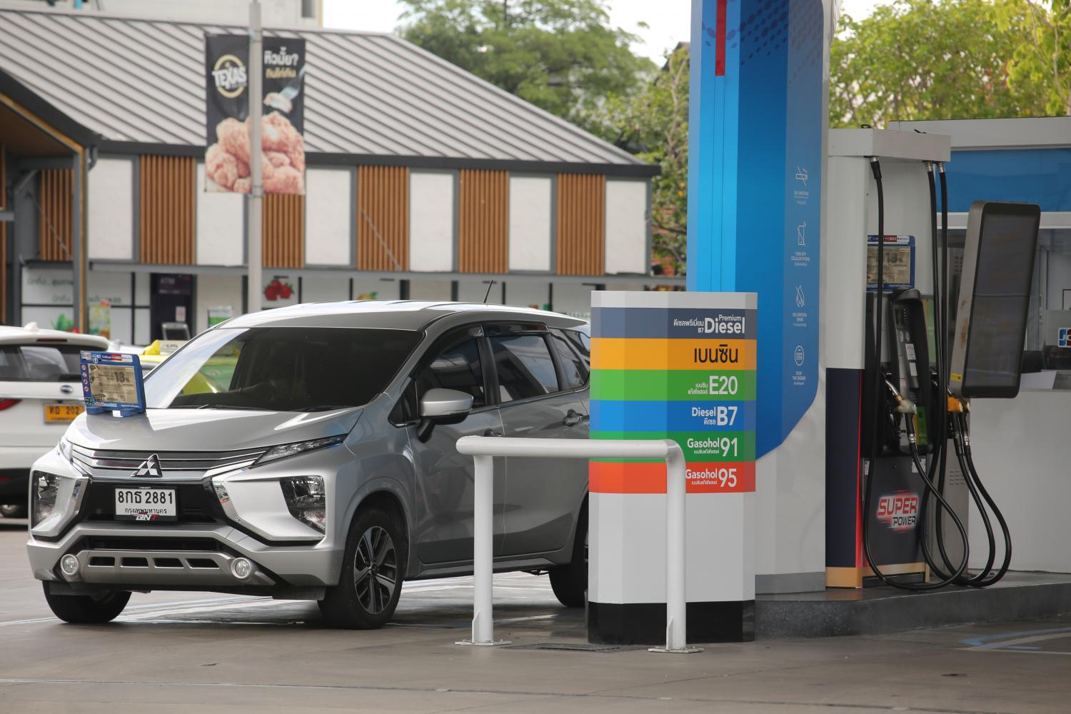 A pickup refuels at a petrol station. The consumption of diesel in Thailand totals 66 million litres daily.