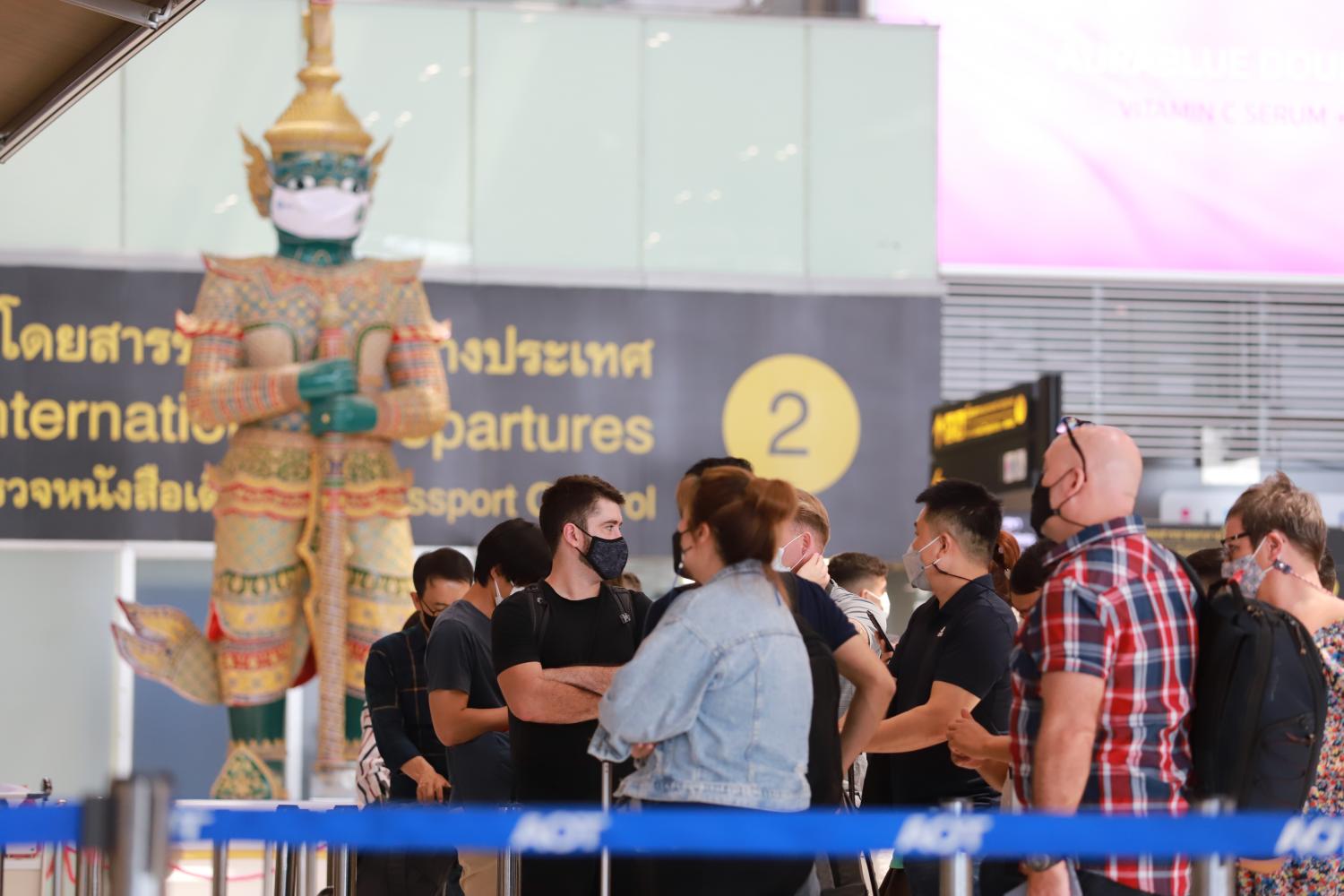 Passengers queue to check in for their flight at Suvarnabhumi airport on June 24, 2022. (Photo: Somchai Poomlard)