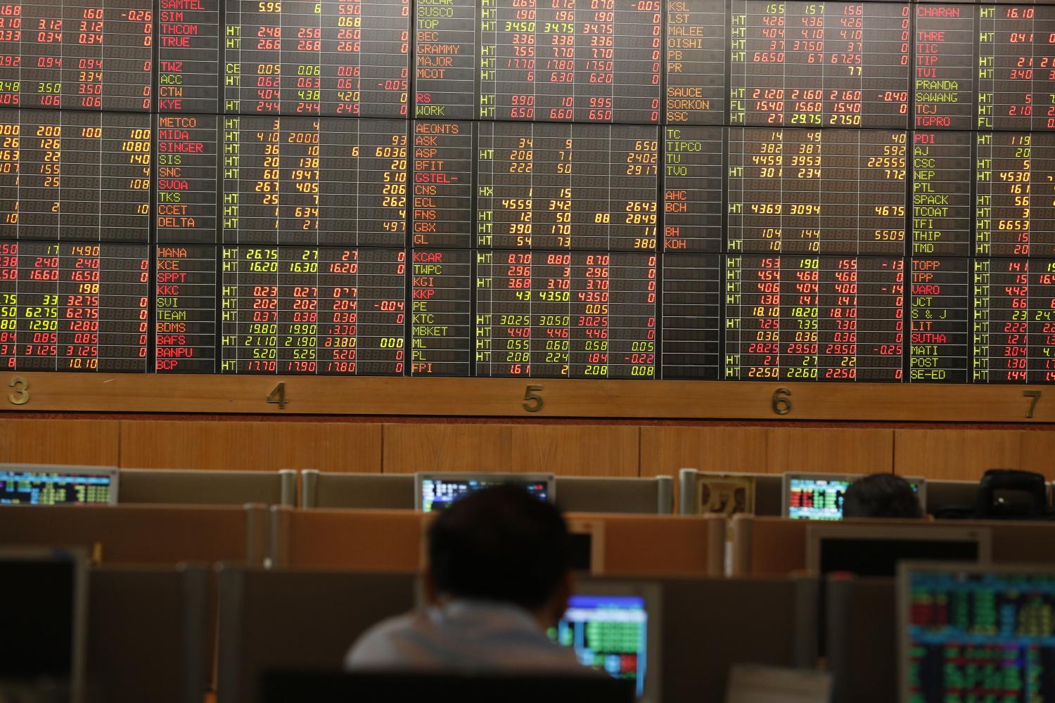 An investor looks at an electronic display of stock indices at Asia Plus Securities. (Photo: Pornprom Satrabhaya)