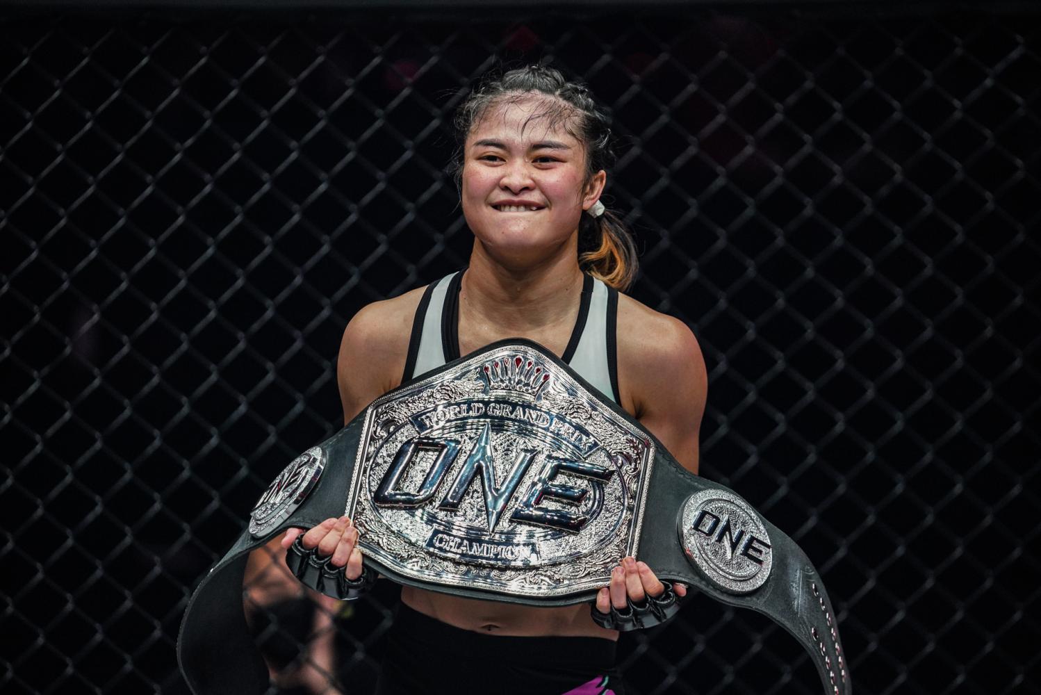 Thai fighter Stamp Fairtex poses with the World Grand Prix belt.