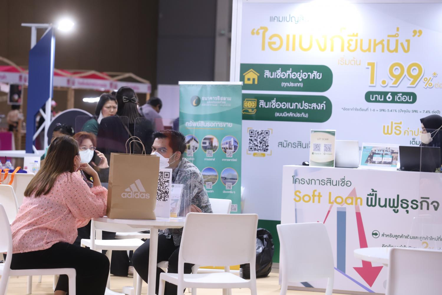 People discuss loans at a loan expo held at Impact Muang Thong Thani last month.  (Photo: Pornprom Satrabhaya)