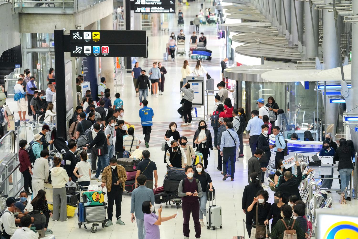 Tourists at the arrival hall of Suvarnabhumi airport, which has tallied an influx of travellers the past few months. (Reuters photo)