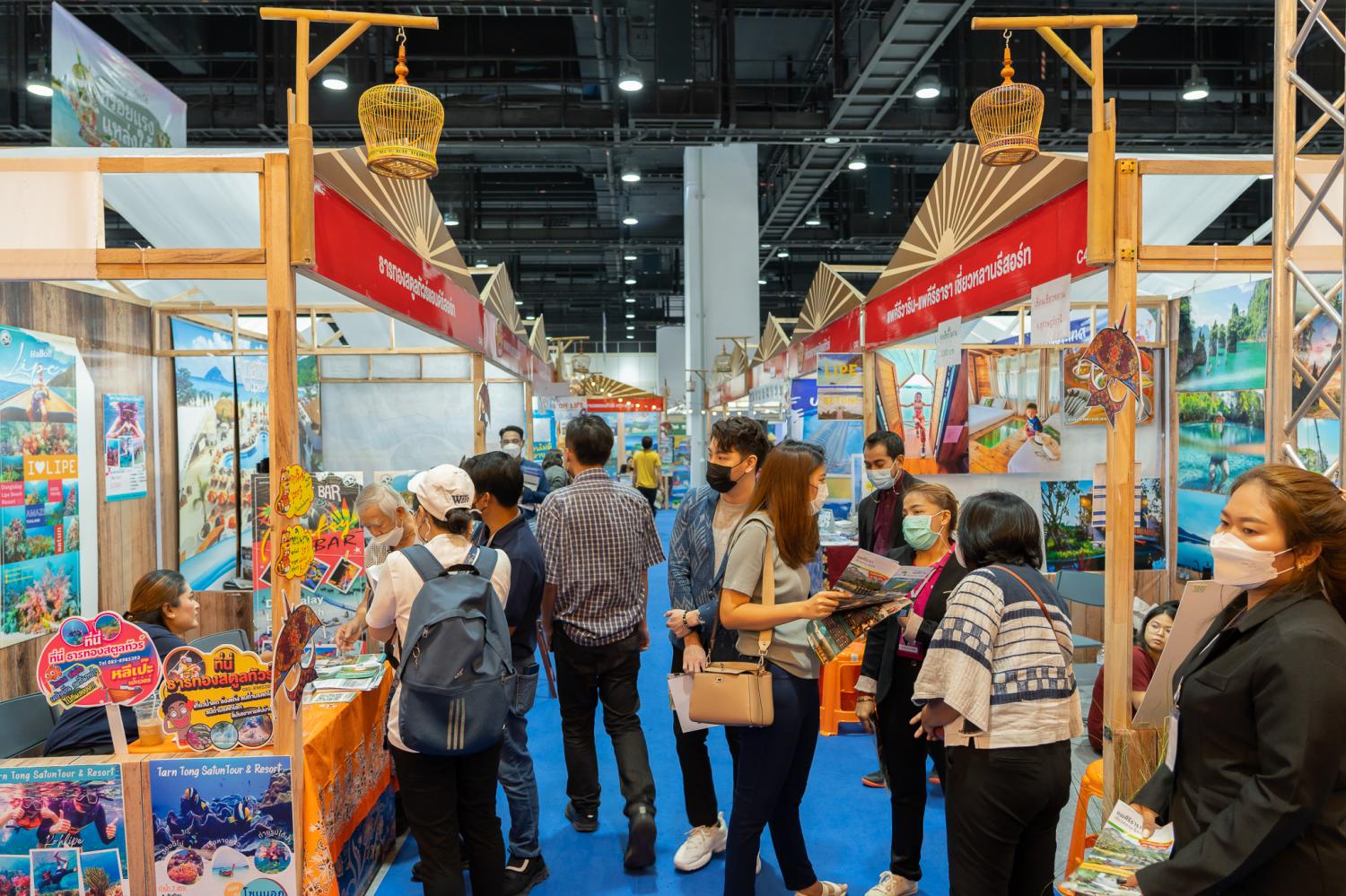 People browse deals at a travel fair held at Queen Sirikit National Convention Center.