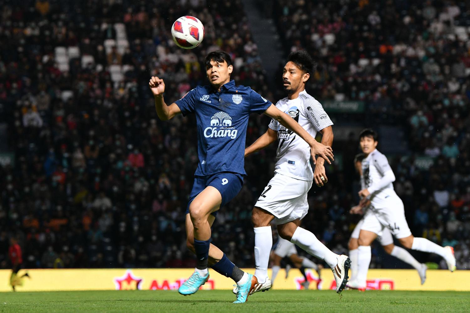 Buriram's Supachai Chaided, left, in action against Chonburi.