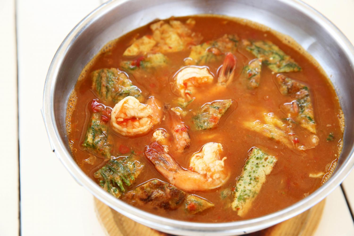 Soul food: A pot of Kaeng Som Cha-om Choop Khai Kung (sour soup with prawn and cha-om omelette). Kaeng Som is a traditional dish that contains mixed vegetables and meat like shrimp or fish.