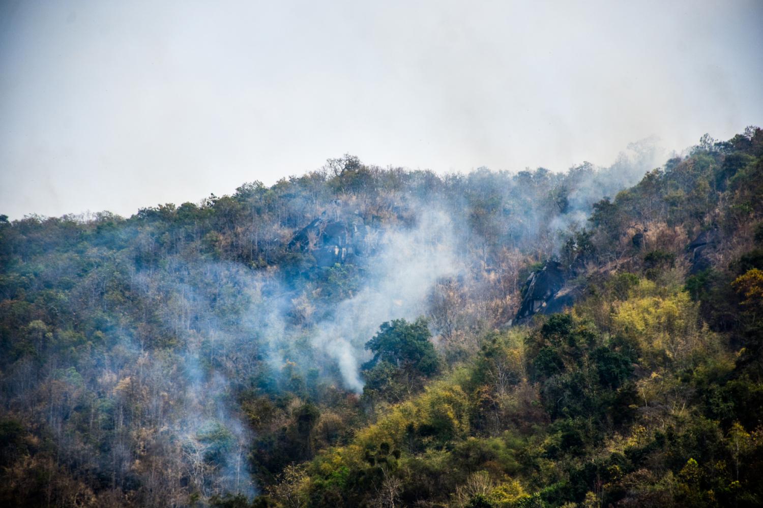 No respite: White smoke covers the forest area of Phu Sanao mountain in Loei after soldiers from the 28th Military Circle's disaster relief centre and the Internal Security Operations Command put out a fire on Wednesday. Forest fires are one of the leading causes of air pollution during the dry season.