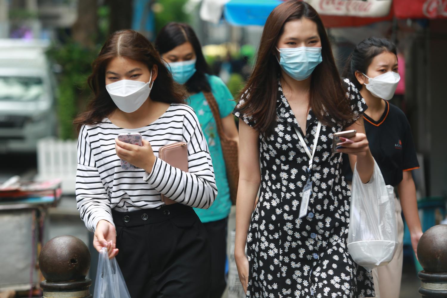 Female staff walk during lunch hour on Silom Road in Bangkok. A recent study found more than half of Thai female employees age 35 and older are interested in taking additional courses. Somchai Poomlard