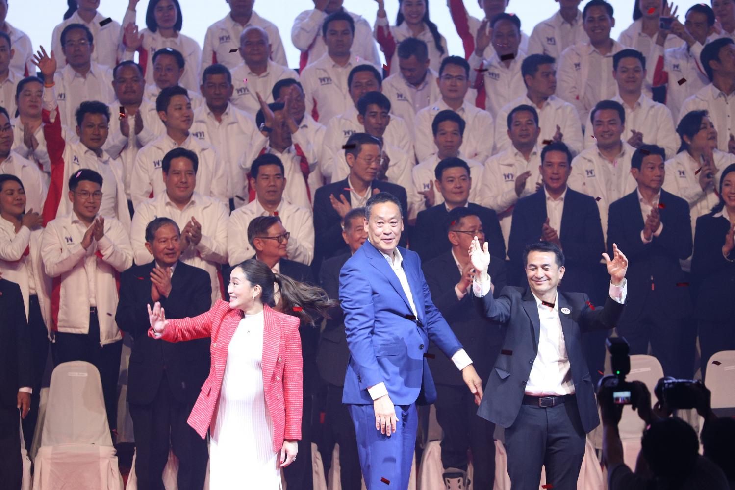 Paetongtarn Shinawatra, left, head of the 'Pheu Thai Family', greets Pheu Thai supporters together with her adviser, Srettha Thavisin, middle, and Dr Cholnan Srikaew, right, the party leader, at Thammasat University's Rangsit campus in Pathum Thani on Friday. (Photo: Pattarapong Chatpattarasill)