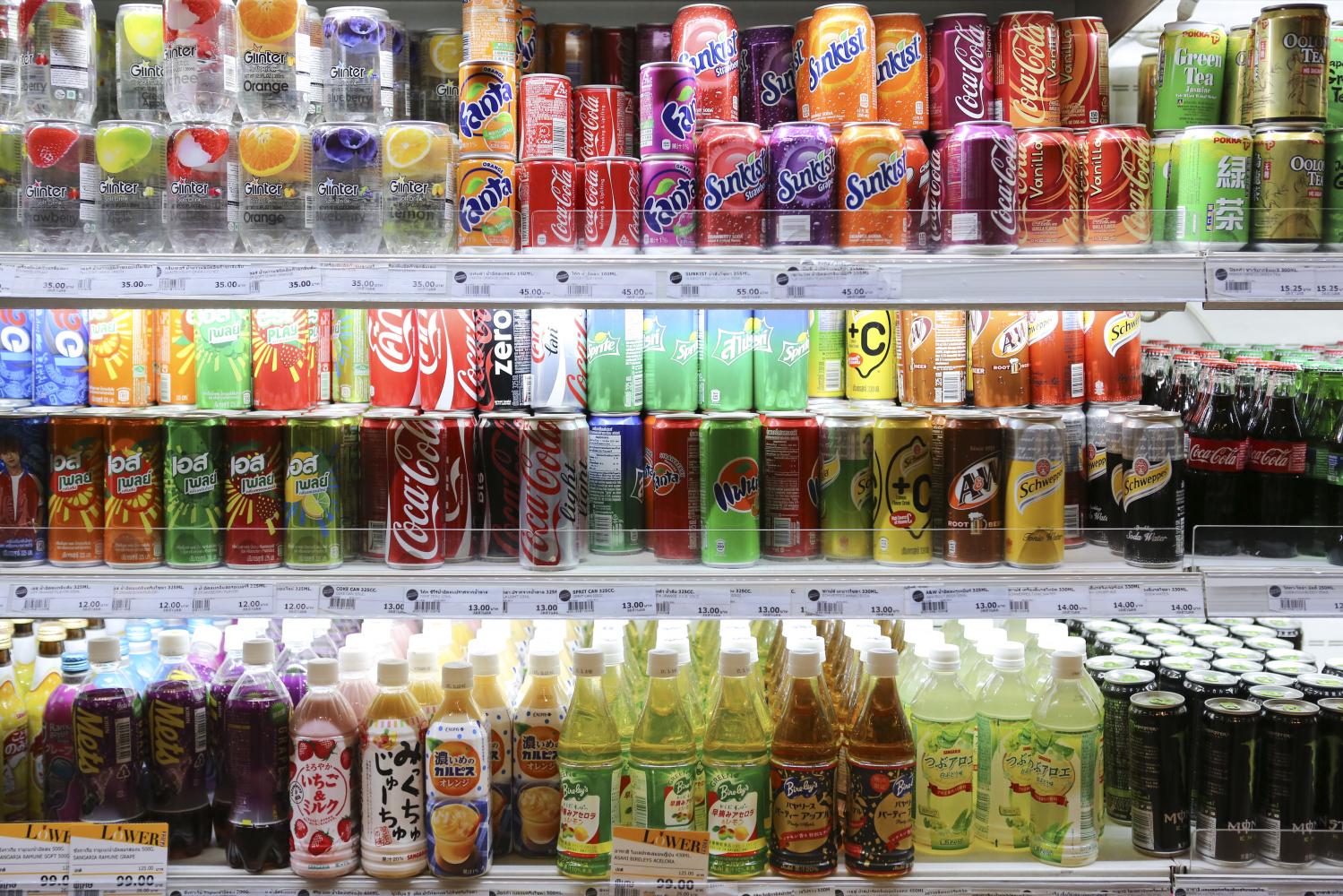 Beverages stacked up at a convenience store. The government has enforced a sugar-based excise tax on beverages since 2017. (Bangkok Post file photo)