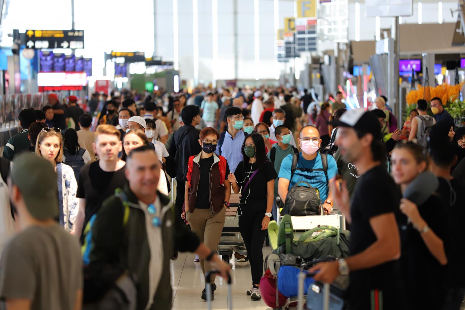 Travellers crowd the departures hall at Suvarnabhumi airport during the Songkran festival in 2023. A proposed departure tax aims to generate revenue for the government.