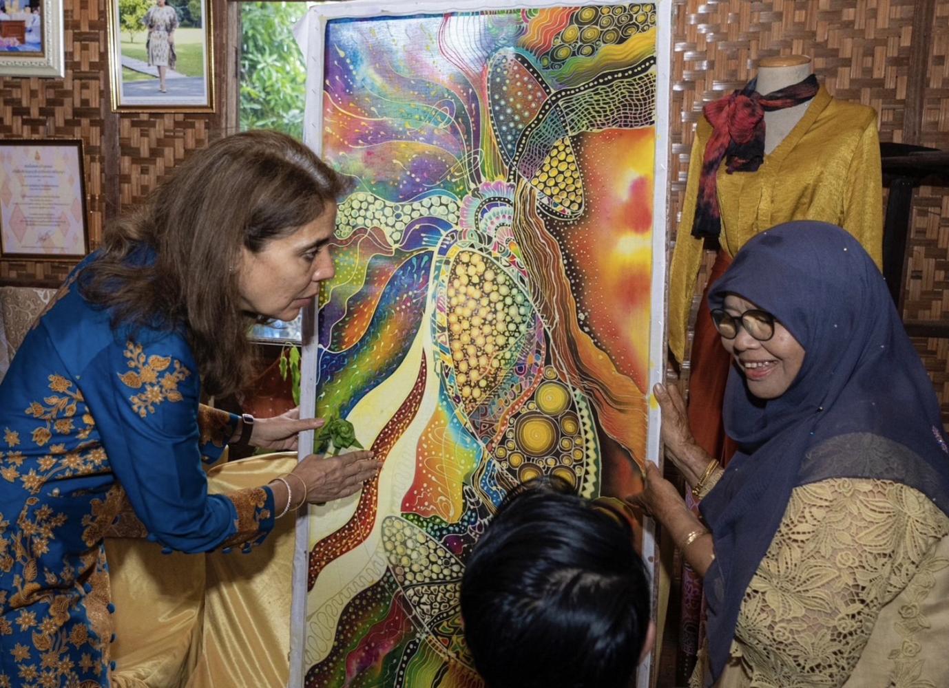 Gita Sabharwal, UN Resident Coordinator for Thailand, left, shows an interest in batik art projects while visiting a batik group in Pattani on May 19. Photo by the Interior Ministry.