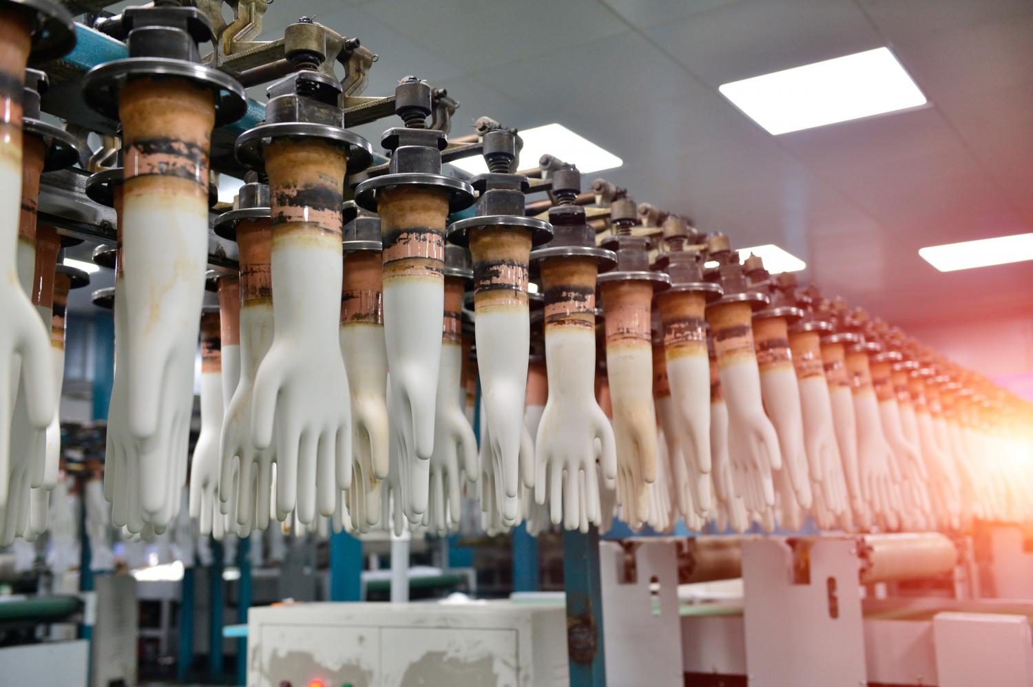 Rubber gloves on a production line during manufacturing at a factory.