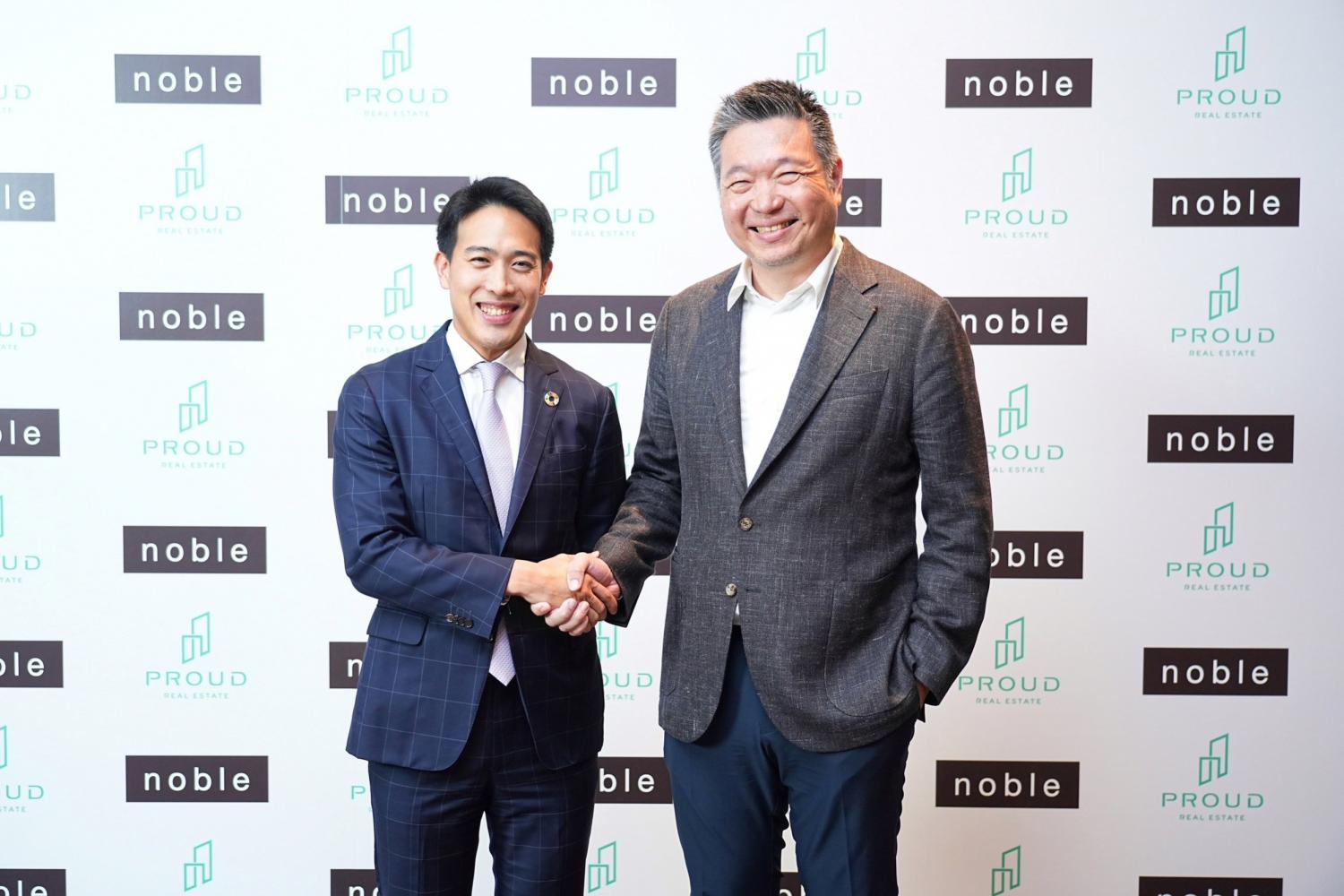 Mr Pasu, left, and Mr Thongchai shake hands. Mr Pasu said Proud's customer base would now include middle-to-lower-end segments following the aquisitions.