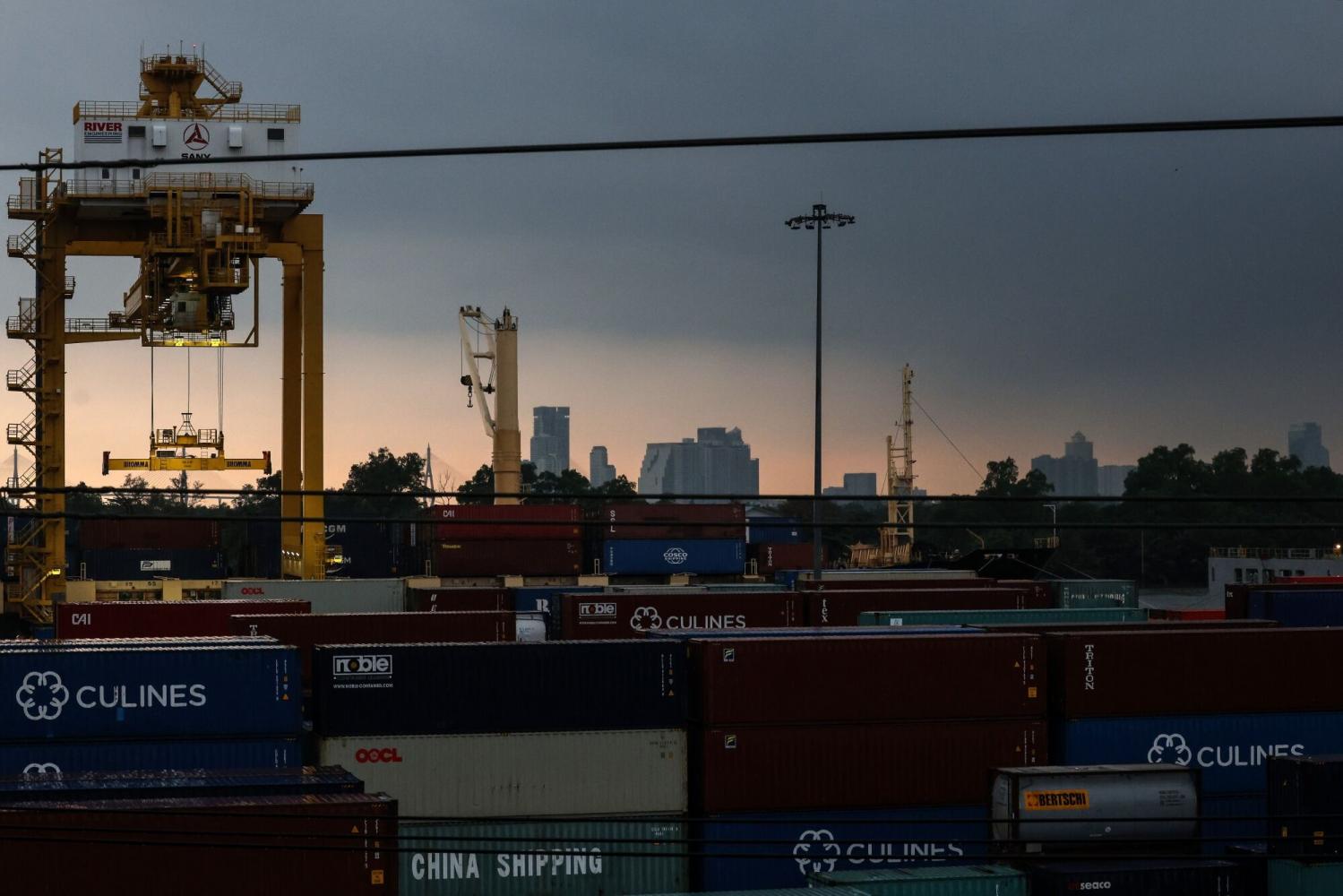 Gantry cranes are pictured amid containers stacked up at Bangkok Port. Thai exports dropped for a 10th consecutive month in July. Bloomberg