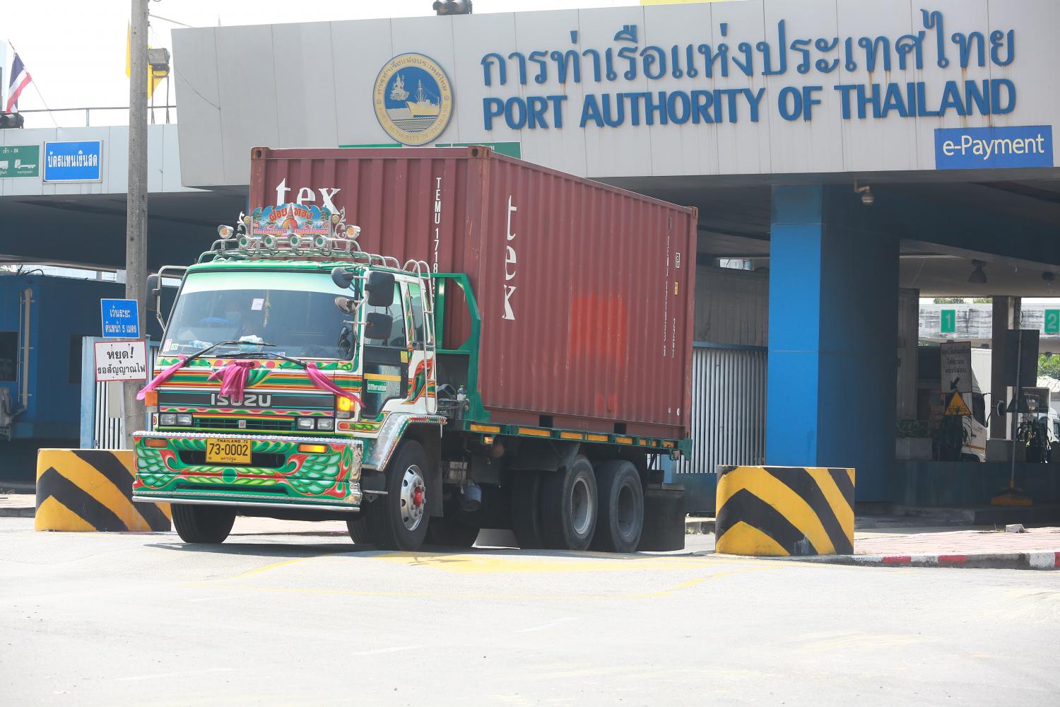 A truck loaded with a container departs from Bangkok Port in Bangkok's Klong Toey district. (Photo: Somchai Poomlard)