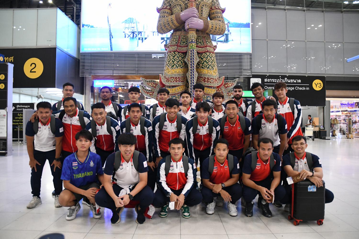 Carrying hopes: Thailand U23 coach Issara Sritaro and his team before departing for the Asian Games in Hangzhou, China, early Saturday morning.