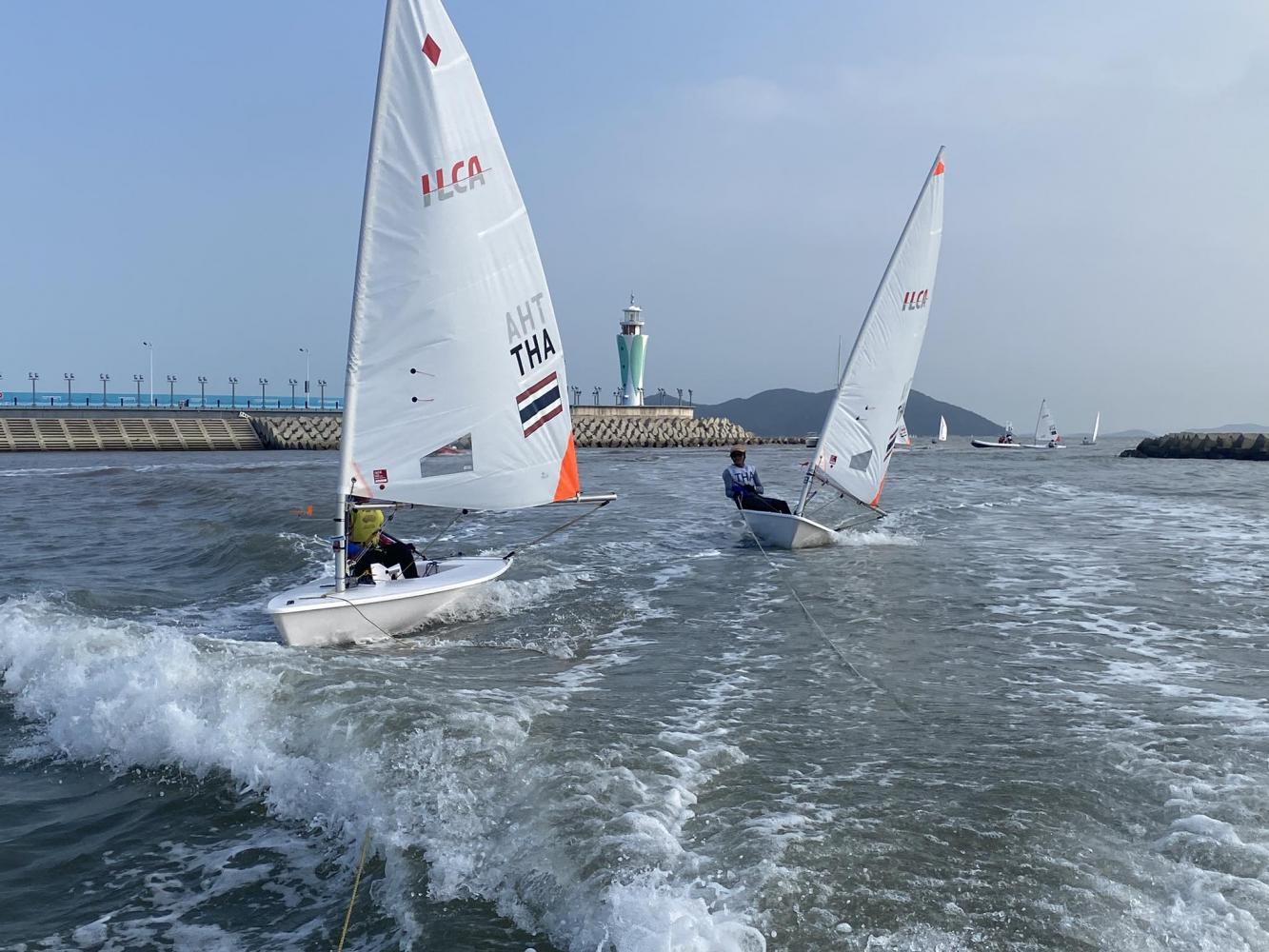 Thai sailors Noppassorn Khunboonjan, left, and Weka Bhanubandh compete during Tuesday's Dinghy ILCA4 final races. (Photo supplied)