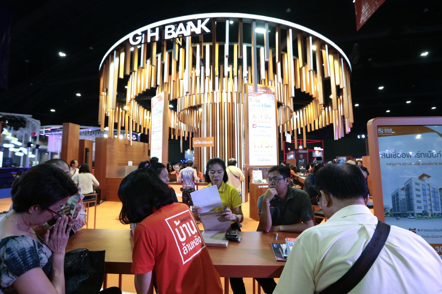 Visitors peruse mortgages at the GH Bank booth at a previous Money Expo. The bank's outstanding loans to date total 1.65 trillion baht, up 3.74% since the end of last year. (Photo: Patipat Janthong)