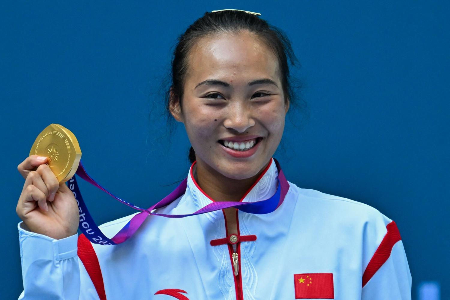 Chinese tennis player Zheng Qinwen poses with her gold medal. (Photo: AFP)