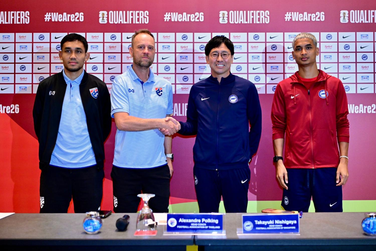 Thailand coach Mano Polking, centre, and Singapore boss Takayuki Nishigaya shake hands as Thailand striker Teerasil Dangda looks on during a press conference on Monday.