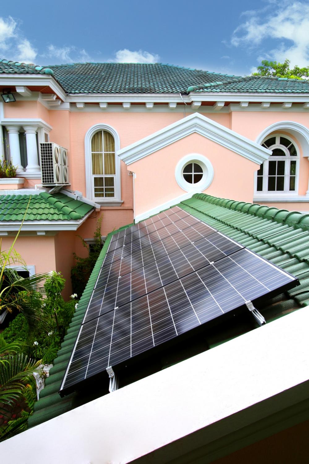 Solar panels line the rooftop of a housing project.
