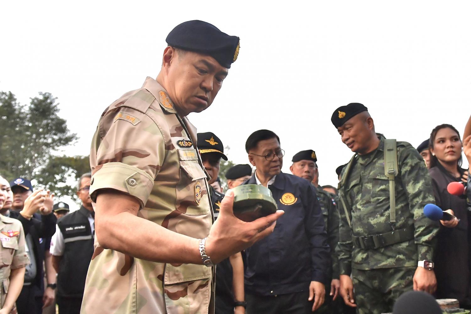 Mr Anutin inspects a recovered PMN-2 mine while receiving a briefing on border security at the 11th Infantry Battalion at Phu Makua, Kantharalak district, Si Sa Ket, earlier this month.  Government House