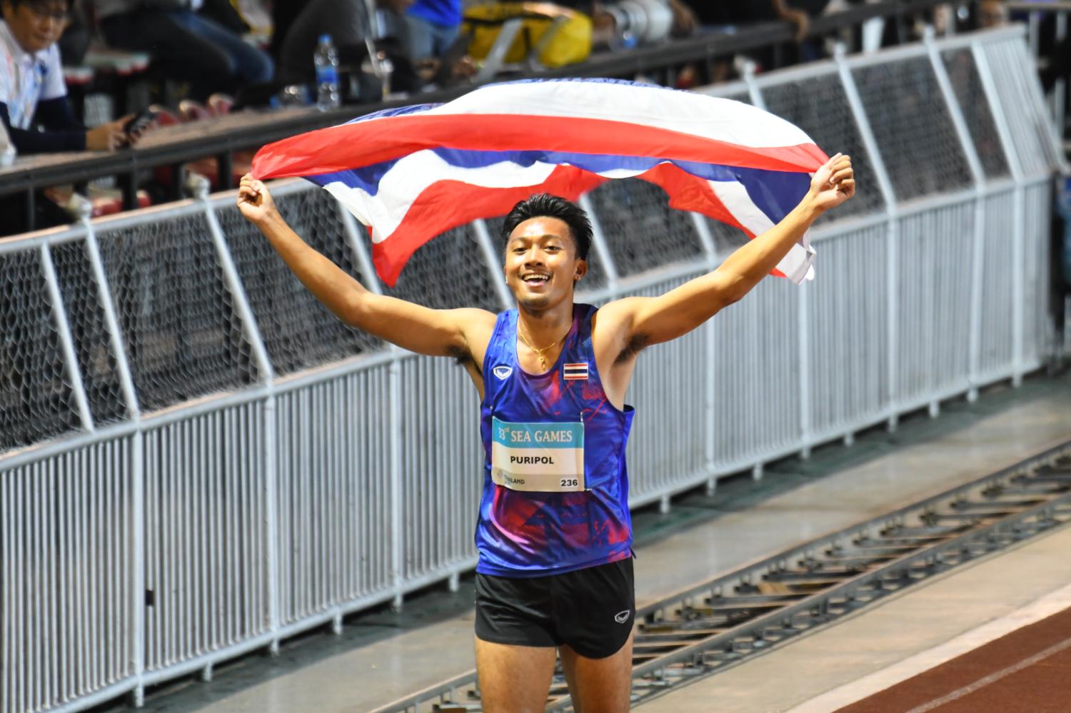 Puripol Boonson celebrates after winning the men's 100m race at the 33rd SEA Games.  Nutthawat Wichieanbut