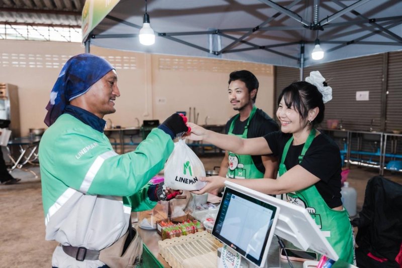 A Line Man Wongnai driver picks up food for delivery at a local food outlet. The company aims to outpace market growth despite ongoing headwinds.