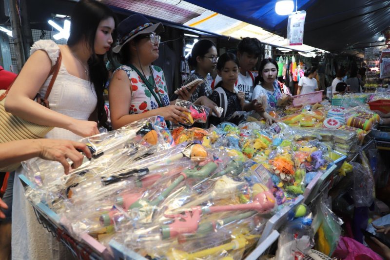 Shoppers browse Songkran items, including toys and water guns, at Sampheng market ahead of the Thai New Year. The long holiday is expected to dampen diesel demand as state agencies and businesses close. (Photo: Apichart Jinakul)