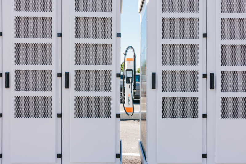 An EV charging outlet is pictured between cabinets at a Kempower-developed charging facility.