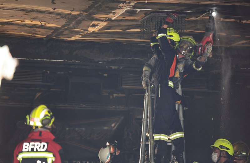 Members of the emergency response team inspect the ceiling of Rong Beer Na Ladprao at the site of a deadly fire in Bangkok on Tuesday. (Photo: Reuters)