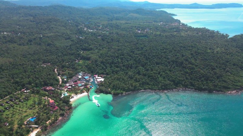An aerial view shows the lush, forested coastline and clear turquoise waters of Koh Kut in Trat province. (Photo: Jakkrit Waewklayhong)