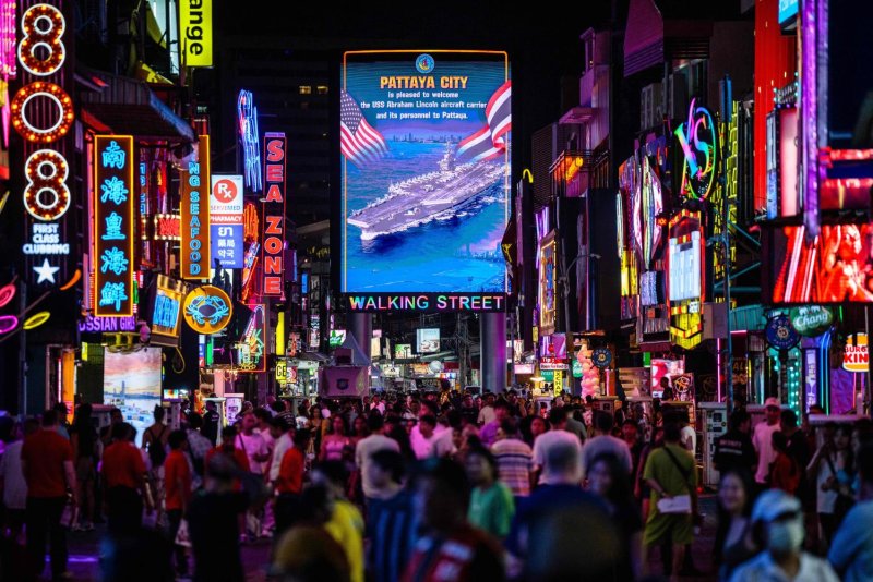 People stroll along Pattaya Walking Street. Analysts expect a strong fourth quarter for the tourism sector this year. AFP
