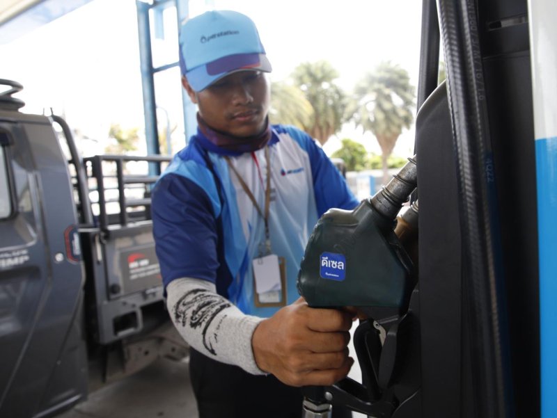 A petrol station attendant fills a vehicle with diesel. Energy prices are expected to remain high through the end of the cool season next year.  Pattarapong Chatpattarasill