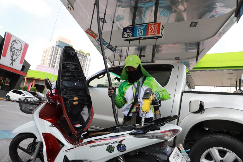 A petrol station attendant refuels a motorcycle. Retail prices of gasohol E20 and biodiesel B20 are set to fall after the government approved excise tax cuts to encourage greater use of domestically produced biofuels. Somchai Poomlard